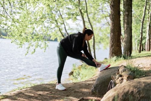 A person walking on a leafy path